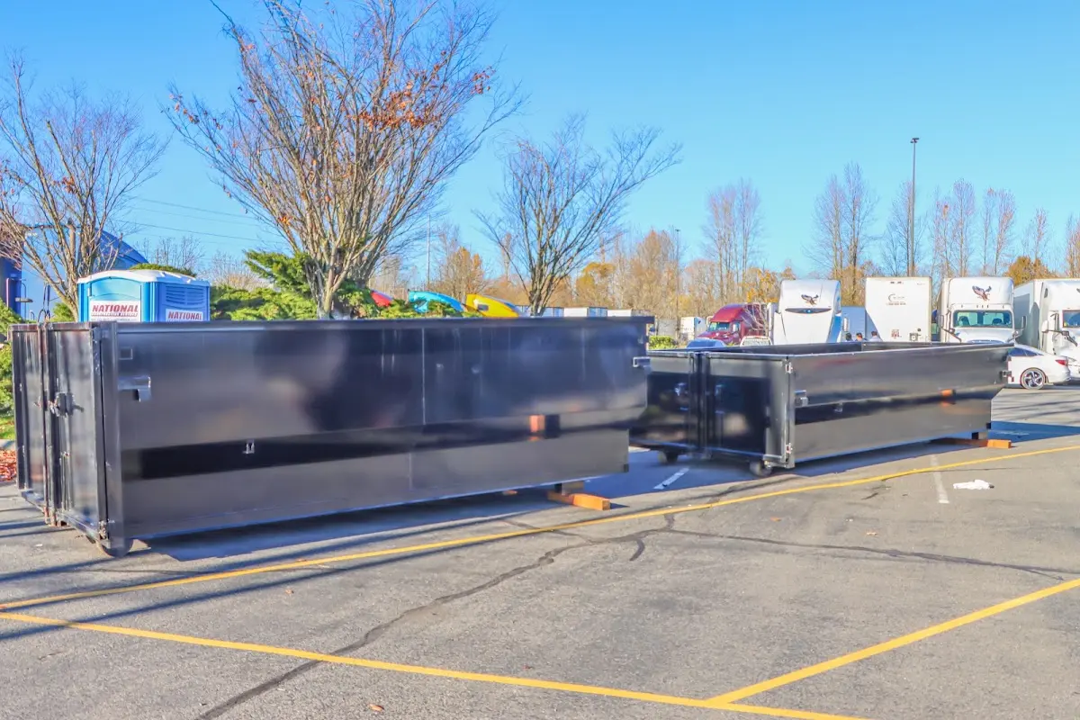 Professional dumpster rental service with roll-off container on residential driveway in Cedar Falls
